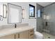Contemporary bathroom with a wood vanity, black hardware, and a shower with a modern gray tile design at 7341 E Sunnyside Dr, Scottsdale, AZ 85260
