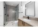 Modern bathroom featuring a glass-enclosed shower with stylish gray tiling and matte black fixtures at 7341 E Sunnyside Dr, Scottsdale, AZ 85260