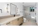 Bright bathroom showcasing a sleek vanity, a minimalist mirror, and a shower with white herringbone tile at 7341 E Sunnyside Dr, Scottsdale, AZ 85260