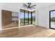 Bright bedroom featuring hardwood floors, a large window, and custom built-in shelving at 7341 E Sunnyside Dr, Scottsdale, AZ 85260