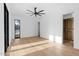 Spacious bedroom with hardwood floors, a ceiling fan, and a walk-in closet at 7341 E Sunnyside Dr, Scottsdale, AZ 85260