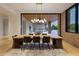 Dining room with seating for eight and a sliding glass door to the patio and outdoor kitchen at 7341 E Sunnyside Dr, Scottsdale, AZ 85260