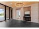 Grand entryway featuring black marble floors, brick walls, wood ceiling, and a chandelier, creating a modern aesthetic at 7341 E Sunnyside Dr, Scottsdale, AZ 85260