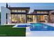 Stunning modern home with a pool, manicured lawn, and ample windows for natural light at 7341 E Sunnyside Dr, Scottsdale, AZ 85260