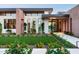 Stunning modern home with desert landscaping, manicured lawn, and large windows, creating an inviting curb appeal at 7341 E Sunnyside Dr, Scottsdale, AZ 85260