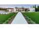 Striking modern home featuring a manicured lawn, geometric landscaping and an inviting stone walkway at 7341 E Sunnyside Dr, Scottsdale, AZ 85260