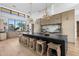 Modern kitchen with island, seating, and custom cabinets and large windows at 7341 E Sunnyside Dr, Scottsdale, AZ 85260