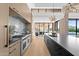 Bright, modern kitchen with large island, stainless steel appliances and adjacent dining area at 7341 E Sunnyside Dr, Scottsdale, AZ 85260