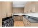 Well-organized laundry room with wood cabinets, sleek countertops, and modern washer and dryer units at 7341 E Sunnyside Dr, Scottsdale, AZ 85260