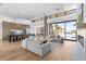 Open-concept living room with modern furnishings, hardwood floors, and large windows offering scenic outdoor views at 7341 E Sunnyside Dr, Scottsdale, AZ 85260