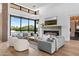 Bright, open living room with fireplace, comfortable seating, and expansive backyard views at 7341 E Sunnyside Dr, Scottsdale, AZ 85260