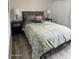 Comfortable bedroom with queen bed, wood-look flooring, neutral walls, and side tables with lamps at 7409 N Via Camello Del Norte -- # 138, Scottsdale, AZ 85258