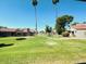 Well-maintained community lawn area surrounded by lush greenery and mature trees at 7409 N Via Camello Del Norte -- # 138, Scottsdale, AZ 85258