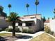 Inviting house featuring desert landscaping and palm trees against a clear blue sky at 7409 N Via Camello Del Norte -- # 138, Scottsdale, AZ 85258