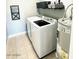 This laundry room features tile floors and a full size washer and dryer at 7409 N Via Camello Del Norte -- # 138, Scottsdale, AZ 85258