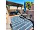Inviting outdoor patio with comfortable seating, shade covering and striped rug at 7409 N Via Camello Del Norte -- # 138, Scottsdale, AZ 85258