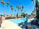 Community pool with clear blue water, surrounded by palm trees and seating areas, ideal for relaxation at 7409 N Via Camello Del Norte -- # 138, Scottsdale, AZ 85258