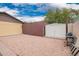 Spacious backyard with gravel, a storage shed, and privacy fencing offers ample space and practicality at 7755 W Cora Ln, Phoenix, AZ 85033