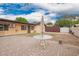 Cozy backyard featuring a brick patio and shade umbrella for outdoor relaxation and entertaining at 7755 W Cora Ln, Phoenix, AZ 85033