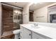 Bathroom features a stall shower with tile walls, stone floors, and a modern vanity at 7755 W Cora Ln, Phoenix, AZ 85033