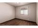 Simple bedroom featuring a ceiling fan, tile floors, and standard window at 7755 W Cora Ln, Phoenix, AZ 85033