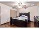 Bedroom features a dark wood bed set, ceiling fan and tile floors at 7755 W Cora Ln, Phoenix, AZ 85033
