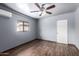 This bedroom features a ceiling fan and a view of the backyard pool at 7755 W Cora Ln, Phoenix, AZ 85033