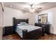 Bedroom features a dark wood bed set, ceiling fan and tile floors at 7755 W Cora Ln, Phoenix, AZ 85033