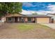 Beautiful single-story home with a well-maintained lawn and attached two car garage at 7755 W Cora Ln, Phoenix, AZ 85033
