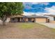 Charming single-story home with a well-manicured lawn and inviting curb appeal at 7755 W Cora Ln, Phoenix, AZ 85033