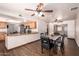 Open kitchen and dining area with hardwood floors, ceiling fans, and granite counters at 7755 W Cora Ln, Phoenix, AZ 85033