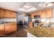 Bright kitchen with stainless steel appliances, light colored cabinetry, and granite countertops at 7755 W Cora Ln, Phoenix, AZ 85033