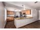 Modern kitchen featuring hardwood floors, granite countertops, and a breakfast bar at 7755 W Cora Ln, Phoenix, AZ 85033