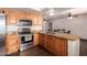 Updated kitchen featuring hardwood floors, stainless appliances, and granite countertops at 7755 W Cora Ln, Phoenix, AZ 85033
