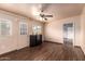 This living room features wood floors, neutral paint, and a ceiling fan at 7755 W Cora Ln, Phoenix, AZ 85033
