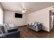 Inviting living room with wood floors, ceiling fan, large window, and comfortable seating at 7755 W Cora Ln, Phoenix, AZ 85033