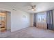 Cozy bedroom featuring neutral carpeting, ceiling fan, and ample closet space at 7830 E Valley Vista Dr, Scottsdale, AZ 85250