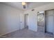 Bright bedroom featuring neutral paint, plush carpeting, ceiling fan, and mirrored closet doors at 7830 E Valley Vista Dr, Scottsdale, AZ 85250