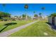A serene community pool area is surrounded by lush greenery and a secure fence at 7830 E Valley Vista Dr, Scottsdale, AZ 85250