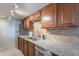 Well-lit kitchen featuring granite countertops, stainless steel appliances, and wooden cabinets at 7830 E Valley Vista Dr, Scottsdale, AZ 85250