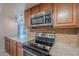 Modern kitchen with granite countertops, stainless steel appliances and wooden cabinets at 7830 E Valley Vista Dr, Scottsdale, AZ 85250
