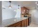 Kitchen with granite counters, stainless appliances and wooden cabinets, open to the home at 7830 E Valley Vista Dr, Scottsdale, AZ 85250