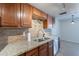 Updated kitchen with granite countertops, tile backsplash, stainless steel appliances and wooden cabinets at 7830 E Valley Vista Dr, Scottsdale, AZ 85250