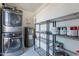 Convenient laundry area with modern washer, dryer, and storage shelves at 7830 E Valley Vista Dr, Scottsdale, AZ 85250