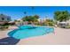 Sparkling community swimming pool and pool deck, surrounded by landscaping, lounge chairs and tables at 7830 E Valley Vista Dr, Scottsdale, AZ 85250