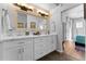 Bathroom featuring double sinks, white cabinets, a large mirror, and modern fixtures at 7887 N 16Th St # 226, Phoenix, AZ 85020