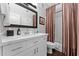 Bright bathroom featuring white cabinets, modern vanity, decorative mirror, and shower-tub combo at 7887 N 16Th St # 226, Phoenix, AZ 85020