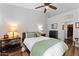 Cozy bedroom featuring a ceiling fan, warm lighting, and an attached walk-in closet at 7887 N 16Th St # 226, Phoenix, AZ 85020