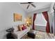 Bedroom featuring a ceiling fan, warm lighting, and a comfortable seating area at 7887 N 16Th St # 226, Phoenix, AZ 85020