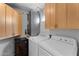Functional laundry room with washer, dryer, and built-in cabinets at 7887 N 16Th St # 226, Phoenix, AZ 85020